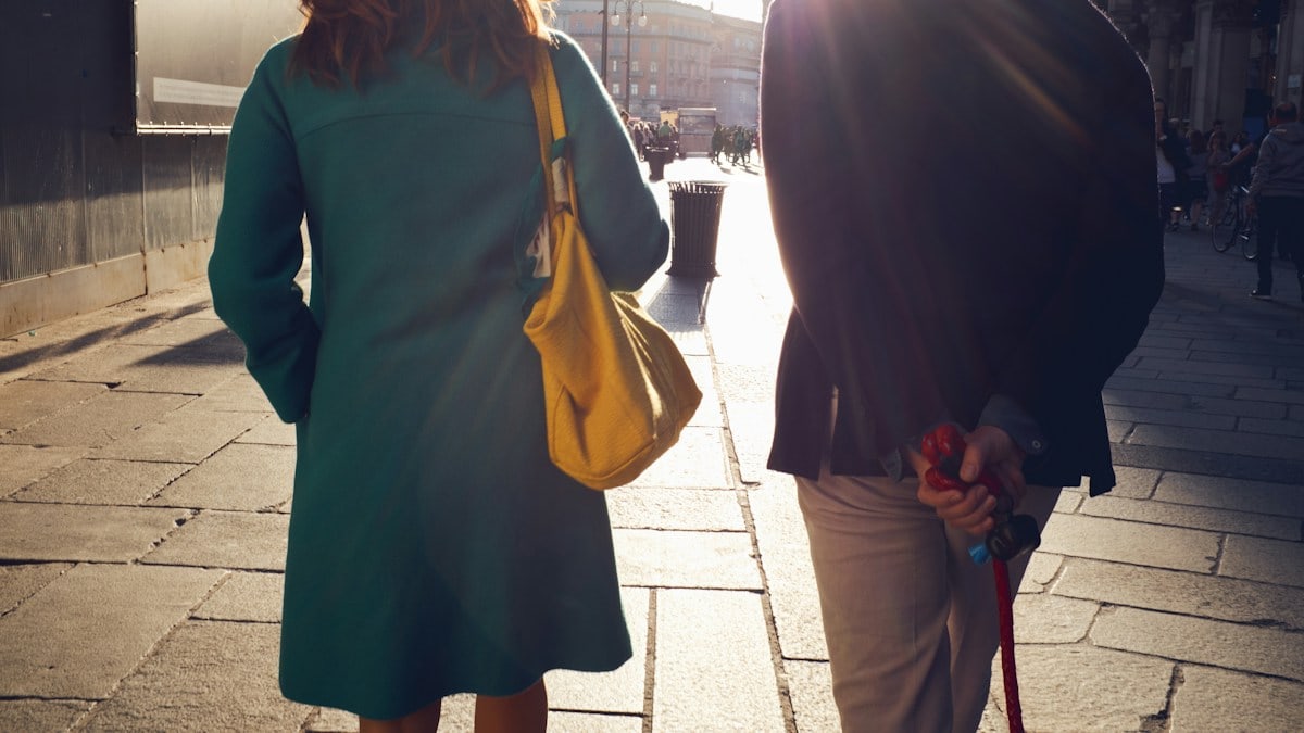woman and man walking near building